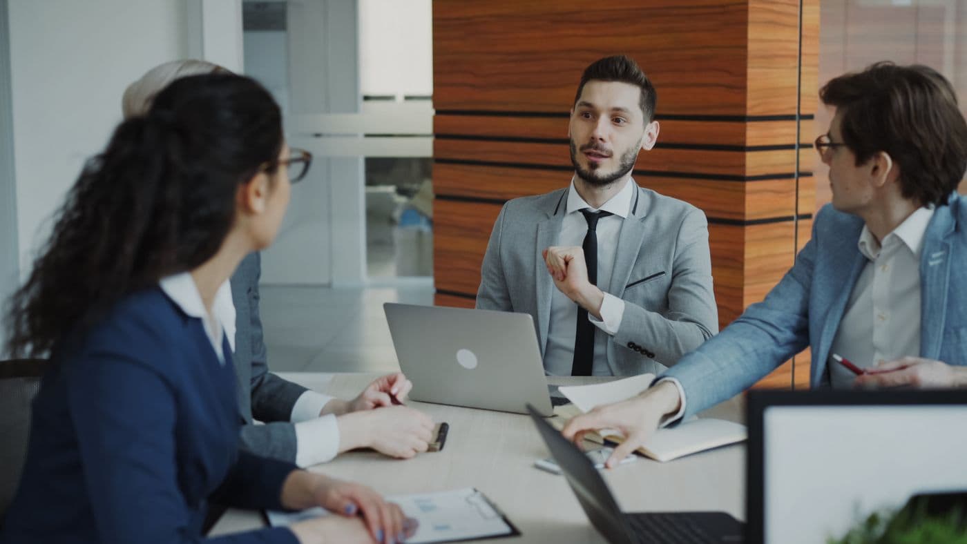 A Stratavest team meeting in a modern office